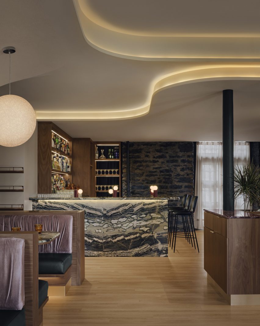 Meja bar terbuat dari marmer berwarna pirus, pistachio, dan krem